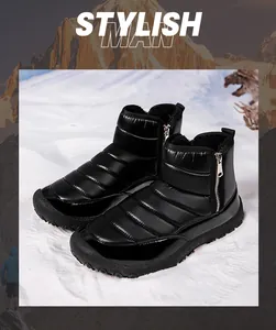 Waterproof men's winter snow boots with quilted down fabric and side zipper in snow landscape
