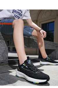 Detail of black mesh running shoe with white shock-absorbing sole and blue accent