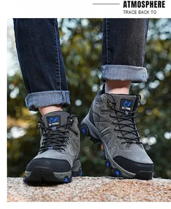 Outdoor view of grey high-top waterproof hiking boots on a male model.