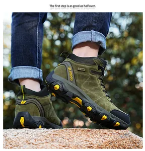 Close-up view of green high-top hiking boots on a rock, showing the anti-slip rubber sole