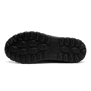 Detail of black non-slip rubber sole with dense oval traction pattern for snow boots