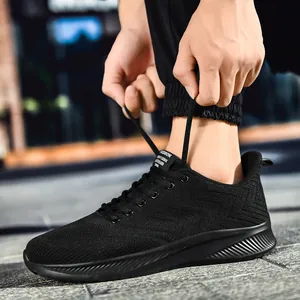 Outdoor shot of men's black breathable knit running sneakers with slip-resistant thick soles
