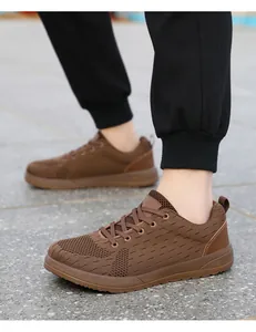 Detail view of brown breathable mesh sneakers showing knit texture and outdoor wear effect