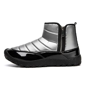 Detail of silver quilted winter boot with waterproof side zipper and thick rubber sole