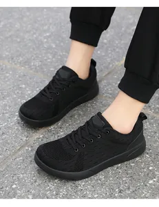 Detailed close-up of men's black knit running shoes with breathable mesh and laces