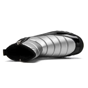 Detail of silver quilted waterproof snow boot showing warm black plush lining and side zipper
