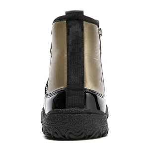 Detail of waterproof snow boots featuring metallic finish and anti-slip rubber sole
