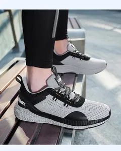 Dettaglio di scarpe sportive traspiranti con suola spessa e rete grigia con cuciture arancioni