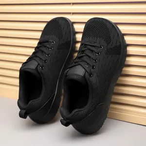 Detailed side view of breathable black mesh running sneakers with thick non-slip soles
