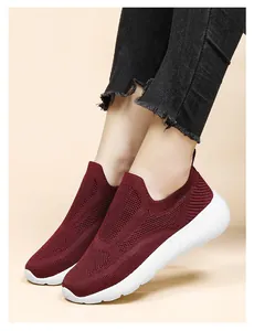 Detail view of wine red breathable knit sneakers with thick white lightweight EVA sole