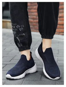 Close-up of breathable 3D fly-knit running sneakers with cushioned white sole on street