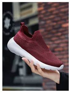 Detailed close-up of burgundy 3D fly-knit upper texture on a breathable slip-on sneaker