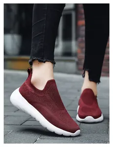 Detail of dark red breathable 3D fly knit slip-on sneakers with cushioned white sole