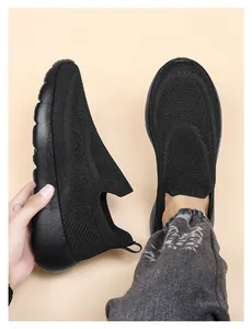 Close-up showing the extreme flexibility and soft knit fabric of the black running shoes