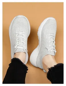 Détail de la texture en maille tricotée blanche respirante et lacets de la chaussure