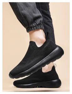 On-foot view of black breathable 3D knit slip-on sneakers with elastic ribbed cuffs