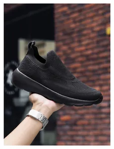Detail of black 3D knit slip-on sneakers showing breathable texture and thick foam sole