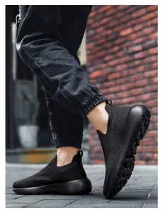 Close-up of black 3D knit breathable running shoes with cushioning soles on street pavement