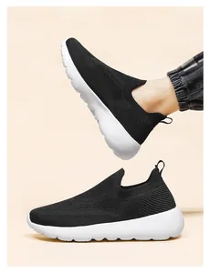Detail of 3D breathable knitted sneakers featuring a slip-on design and thick white sole