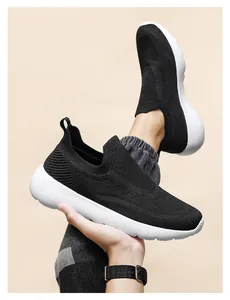 Macro detail of breathable 3D knitted mesh and white cushioned sole on black sneakers
