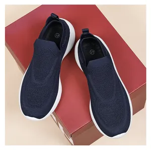 Close-up of dark blue 3D knit slip-on sneakers featuring breathable fabric and white sole