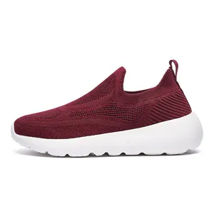 Detailed side view of breathable burgundy 3D fly knit slip-on sneakers with white soles