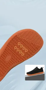 Detail of anti-slip orange rubber sole with wavy traction patterns for sport shoes