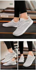 Close-up of wide toe barefoot shoes with breathable mesh and thick soles on a treadmill