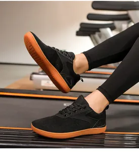 Close-up of black breathable wide-toe barefoot shoes on a treadmill for running and fitness
