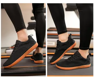 Breathable mesh black sneakers for men and women on a treadmill in a gym setting