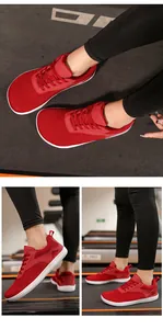 Macro view of red breathable mesh fabric and white flexible sole on athletic walking shoes
