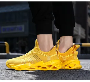 Detail of breathable yellow mesh sneakers with hollow shock-absorbing sole on asphalt