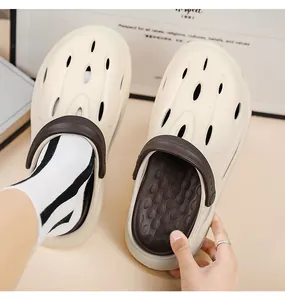 Detail view of beige thick-sole clog shoes with breathable holes and massage footbed