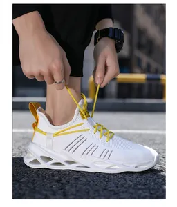 Detail shot of white mesh sneaker featuring vibrant yellow laces and hollow cushioning sole