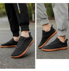 Detail of black mesh walking sneakers for men featuring a durable brown gum rubber sole