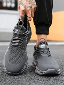 Detailed macro shot of dark grey knit fashion sneaker with sculpted thick sole on street