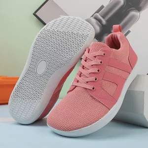 Detail of pink barefoot sneakers showing breathable mesh upper and wave grip rubber sole