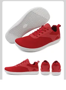 Detailed view of red breathable mesh upper and anti-slip white rubber sole on sneakers