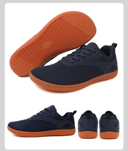 Detail of navy blue barefoot shoes showing breathable mesh upper and gum rubber outsole