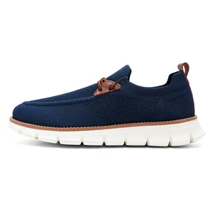 Detailed side view of breathable navy blue knit loafers with thick white non-slip grooved soles