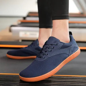 Detail of navy breathable mesh sneaker with rubber sole on a treadmill for running