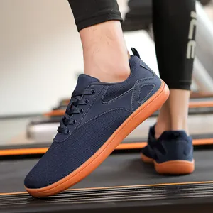 Close-up of breathable blue mesh sneakers with orange soles on a treadmill