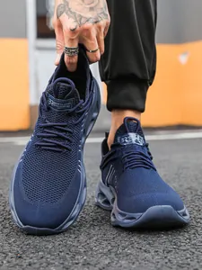 Detailed close-up of navy blue knitted breathable mesh and cushioned hollow sole sneaker