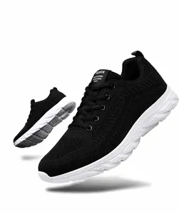 Macro detail of breathable black fly-knit upper and durable white sole on running shoes