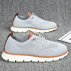 Detail of light gray knit loafers with brown leather accents and thick white cushioned sole