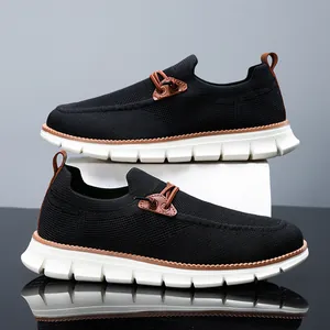 Lightweight black fly-knit loafers with white non-slip soles and brown leather accents
