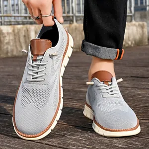 Close-up of grey breathable knitted mesh men's loafers with brown leather accents