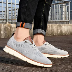 Detail of light gray breathable fly-knit upper and brown leather accents on men's loafers