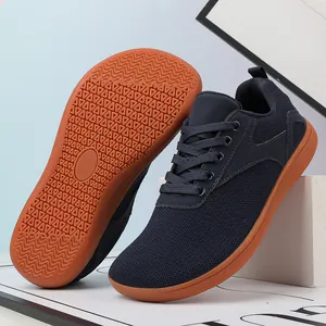 Detail of navy knit sneakers with non-slip gum rubber outsoles and breathable fabric
