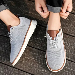 Detail of grey knitted breathable loafer showing leather tongue and textured mesh